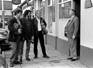 The great Jimmy O'Brien giving a bar of a song at the door of his bar in Killarney to Sliabh Notes trio Donal Murphy, Tommy O'Sullivan and Matt Cranitch in 1996.  Photograph: John Reidy  