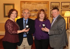 BNI executive director Sandra Hart (left) and  area director Dan Cronin (right) present 15-year service pins to Donie Moynihan and Anne Hannan 